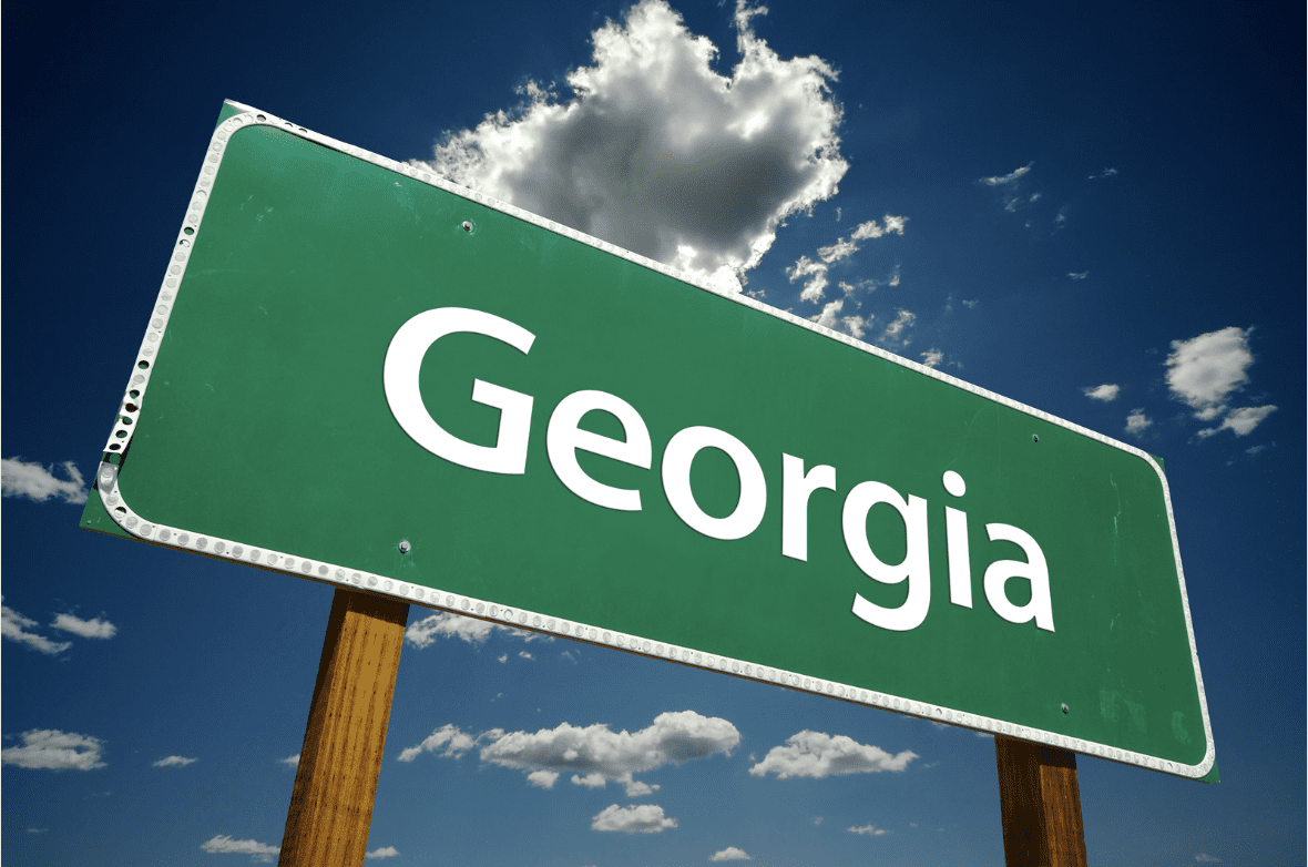Image of a green sign that says "Georgia" and a blue sky in the background.