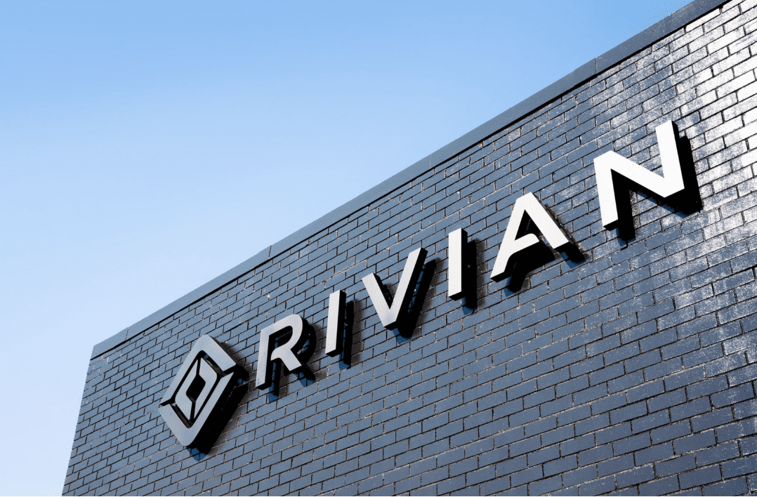 Text says Rivian and it is on the side of a building.
