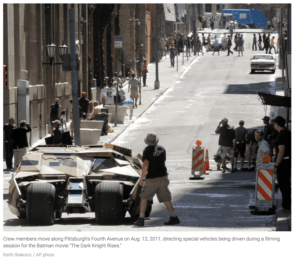   Crew members move along Pittsburgh's Fourth Avenue on Aug. 12, 2011, directing special vehicles being driven during a filming session for the Batman movie "The Dark Knight Rises." Keith Srakocic / AP photo 